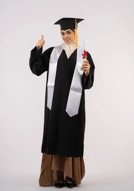 Thumbs up, selfie in graduation gown, Emirati graduate celebrating university graduation, portrait of a young Saudi Arabian Gulf woman wearing a graduation cap and gown holding a diploma and looking at the camera with happy gestures, full body shot, white background