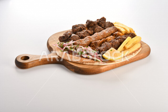 A plate of delicious and delicious mixed grills with crispy potato fingers, grilled meal, delicious meals, hot fast food, Arabic food