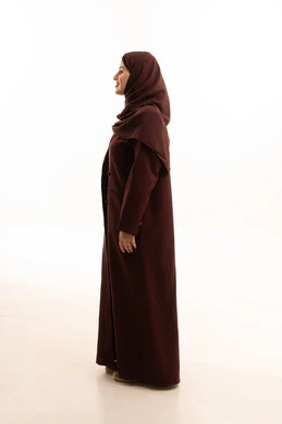 Taking care of the external appearance and elegance, the concept of femininity and softness, a side portrait of a Saudi Arabian Gulf woman standing upright with expressions of self-confidence, full-body, white background.