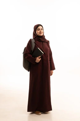 Educational academies in the Gulf countries, education and learning in Saudi colleges, a portrait of a university student, an Arab Gulf Saudi woman wearing a hijab, dressed in an abaya and carrying a backpack, holding university books in her hands, full-body image, white background.