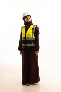 Women's jobs and professions, looking at something, the concept of engineering project management, a young Saudi woman working in the engineering sector, standing with confident gestures, a portrait of an Arab Gulf Saudi engineer wearing a helmet and safety vest standing upright, full-body image, white background. Women's jobs and professions, looking at something, the concept of engineering project management, a young Saudi woman working in the engineering sector, standing with confident gestures, a portrait of an Arab Gulf Saudi engineer wearing a helmet and safety vest standing upright, full-body image, white background.