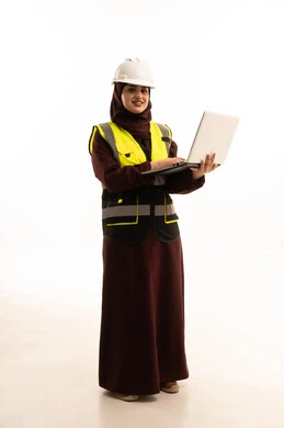 الاشراف الالكتروني على تطبيق المشاريع و الخطط الهندسيه المعمارية في البناء،  بورترية لمهندسة عربية خليجية سعودية ترتدي ستره و خوذة الحماية تستخدم اللابتوب، دمج العمل مع التقنية و التكنولوجيا ، الجسم بالطول الكامل، خلفية بيضاء