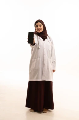 عرض شاشة سوداء فارغة عبر الهاتف المحمول، مفهوم الفحص الطبي، العمل في القطاع الصحي، تقديم الخدمات العلاجية للمرضى, بورتريه لطبيبة عربية خليجية سعودية ترتدي المعطف الطبي تعمل في المراكز الصحية والمستشفيات، الجسم بالطول الكامل، خلفية بيضاء عرض شاشة سوداء فارغة عبر الهاتف المحمول، مفهوم الفحص الطبي، العمل في القطاع الصحي، تقديم الخدمات العلاجية للمرضى, بورتريه لطبيبة عربية خليجية سعودية ترتدي المعطف الطبي تعمل في المراكز الصحية والمستشفيات، الجسم بالطول الكامل، خلفية بيضاء