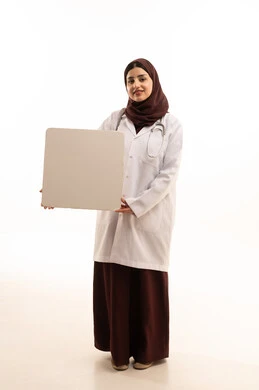 Looking at the camera with gestures of joy, using illustrative boards and educational tools, promoting medical services and products, a rectangular white mockup, a portrait of a smiling Arab Gulf Saudi female doctor wearing a medical coat and holding a blank white board in her hands, full-body, white background.