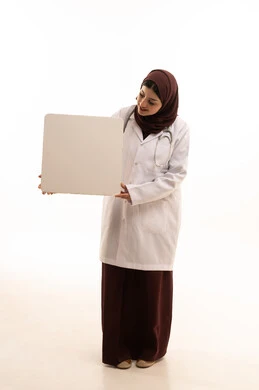 Promoting medical services and products, using illustrative boards and educational tools, white rectangular mockup, portrait of a smiling Arab Gulf Saudi female doctor wearing a medical coat and holding a blank white board in her hands, full-body, white background.
