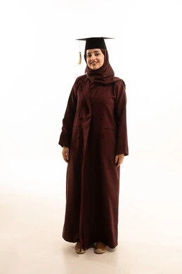 A portrait of a Saudi graduate wearing an abaya and graduation cap celebrating the completion of her university studies, standing upright and taking selfies, looking at the camera with expressions of joy, embodying the concepts of excellence, success, and diligence, full-body image, white background.