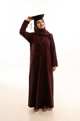 The concept of diligence and excellence, celebrating the completion of university studies, expressions of joy and happiness at achieving the dream of success, a portrait of a Saudi Arabian Gulf female graduate wearing a hijab and an abaya, holding a graduation cap in her hand, looking at the camera with gestures of joy and pride, full-body shot, white background.