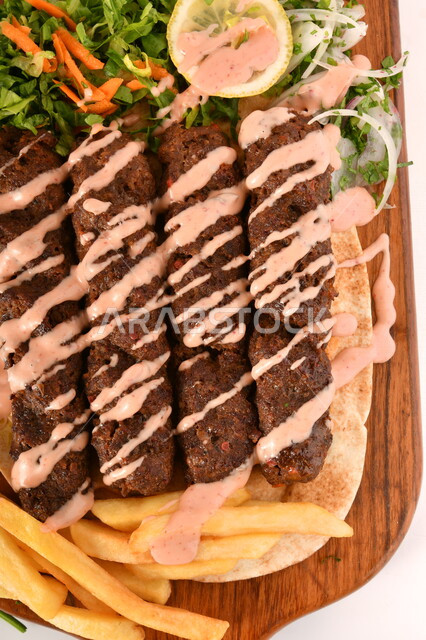 A plate of delicious and delicious mixed grills with crispy potato fingers, grilled meal, delicious meals, hot fast food, Arabic food