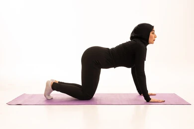 ممارسة التمرينات الأرضية لشد الجسد، مفهوم الرشاقة واللياقة، المحافظة على التوازن الجسدي، نمط حياة صحي ومفيد، انشطة بدنية نسائية، تقوية العضلات ونحت الجسم، بورتريه لشابة عربية خليجية سعودية ترتدي زي رياضي تقوم بممارسة التمرينات الرياضية ،إيماءات الحماس و النشاط، خلفية بيضاء