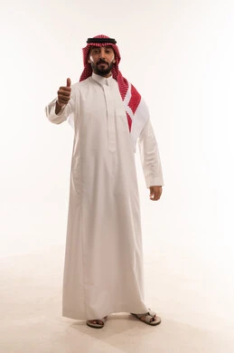 Thumbs up with expressions of quality and admiration, masculinity, elegance, and attention to appearance, a portrait of an Arab Gulf Saudi man wearing traditional thobe and ghutrah, full body length, white background.