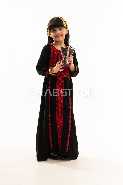 يوم بدينا 1727م, التبخر باستخدام خشب العود والمبخرة باليوم الوطني، ارتداء زي المنطقة الشمالية, ذكرى تأسيس الدولة السعودية الأولى في 22 فبراير, بورتريه لفتاة عربية خليجية سعودية مبتسمة ترتدي المحوثل تقوم بالتعطر والتطيب بالبخور, الجسم بالطول الكامل, خلفية بيضاء