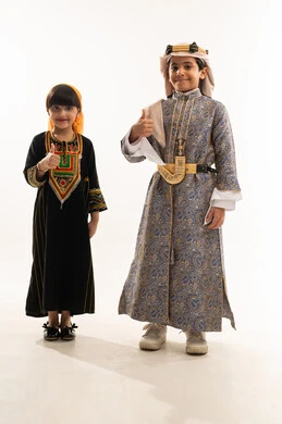 Thumbs up gesture, wearing traditional costumes of the southern and central regions, showing off Saudi heritage, anniversary of the founding of the first Saudi state, February 22, the day of our beginnings, 1727 AD, portrait of a smiling Saudi Arabian Gulf boy and girl, full body, white background
