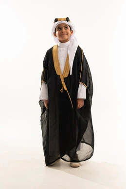 Pride in belonging to the homeland, reviving Saudi heritage, the day of our beginnings in 1727 AD, the anniversary of the founding of the Saudi state on February 22, wearing the costumes of the Eastern Province on national occasions, a portrait of a smiling Saudi Gulf Arab boy wearing a bisht, ghutra, and the founding agal, a full body photo, a white background