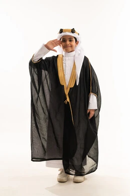 Raising hand to salute respectfully, reviving Saudi heritage, the day we started 1727 AD, the anniversary of the founding of the Saudi state on February 22, wearing the costumes of the Eastern Province on national occasions, a portrait of a smiling Saudi Gulf Arab boy wearing a bisht, ghutra, and the founding agal, a full body photo, a white background