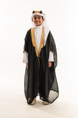Celebrating the founding anniversary of the Saudi state, February 22, standing up straight and looking at the camera proudly, wearing the Eastern Province costumes on national occasions, the day of our beginnings 1727 AD, portrait of a smiling Saudi Arabian Gulf boy wearing a bisht, ghutra and founding agal, full body photo, white background