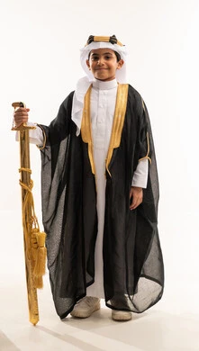 Founding of the Saudi state, February 22, standing up straight and looking at the camera proudly, wearing the costumes of the Eastern Province on national occasions, the day of our beginnings, 1727 AD, portrait of a smiling Saudi Arabian Gulf boy wearing a bisht, ghutra, and founding agal, holding a sword, full body photo, white background