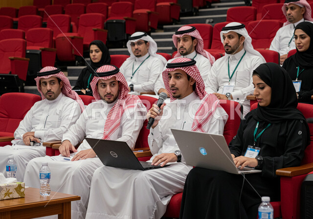 Participation in cultural conferences, mastery of the art of public speaking and oratory, speaking and dialogue skills, a group of Saudi Arabian Gulf businessmen and women attending and presenting workshops and training courses, gestures and expressions of integration, focus and self-confidence
