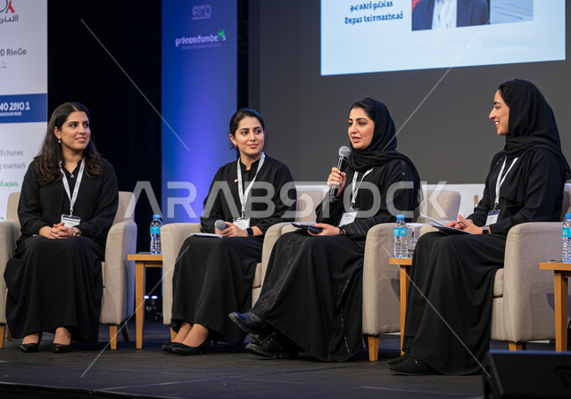 Participation in cultural conferences, mastery of the art of public speaking and oratory, speaking and dialogue skills, a group of Saudi Arabian Gulf businessmen and women attending and presenting workshops and training courses, gestures and expressions of integration, focus and self-confidence