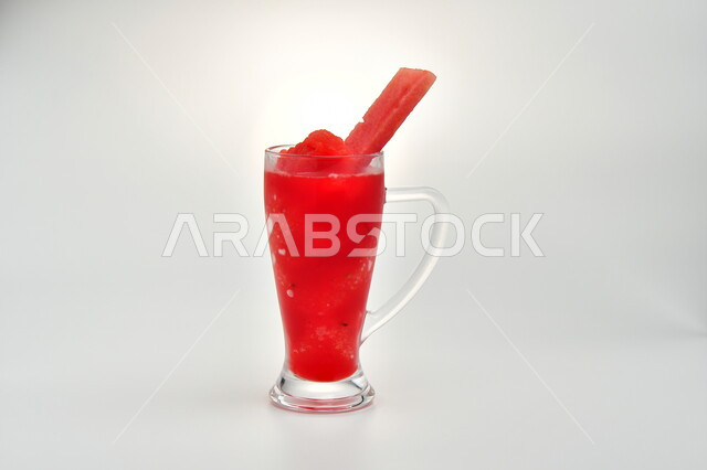 Healthy, beneficial and nutritious drink, refreshing seasonal fresh fruit juice, delicious cold natural cocktail, Saudi local agricultural crops and fruits, a glass of delicious watermelon juice, white background