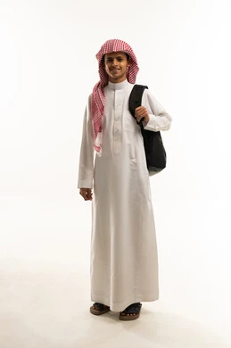 Back to school, preparing for the new academic year, a portrait of an Arab Gulf Saudi student wearing a white thobe and a shemagh, carrying a backpack, looking with gestures of happiness and joy, expressions of enthusiasm and energy, full-body, white background.