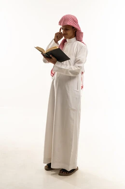 Acquiring knowledge and understanding, enjoying the hobby of reading, a portrait of an Arab Saudi Gulf boy wearing traditional thobe and shemagh holding a book in his hand, looking with gestures of thought and concentration, full-body, white background.