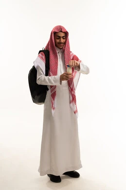 اتباع نظام غذائي صحي، فوائد مشتقات اللبن المتعددة للجسم والعظام,، مفهوم العناية والاهتمام بالصحة, بورتريه لطالب عربي خليجي سعودي يرتدي الزي التقليدي و الشماغ و حقيبة الظهر يمسك بيده زجاجة من الحليب، المحافظة على سلامة الجهاز المناعي، الجسم بالطول الكامل، خلفية بيضاء