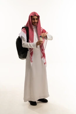 The multiple benefits of dairy products for the body and bones, the concept of care and attention to health, a portrait of an Arab Gulf Saudi student wearing traditional attire and a shemagh, holding a backpack and a bottle of milk, maintaining the integrity of the immune system, following a healthy diet, the full-length body, white background.