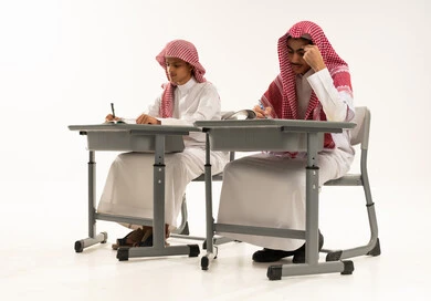 ايماءات الاندماج و التركيز، الجد والاجتهاد للوصول إلى النجاح والتفوق، العودة إلى المدارس، بورترية لطالبان عربيان خليجيان سعوديان يرتدين الثوب الابيض و الشماغ يجلسان على الطاوله فى الفصل يقومان بحل الواجبات ومراجعة الدروس، خلفية بيضاء