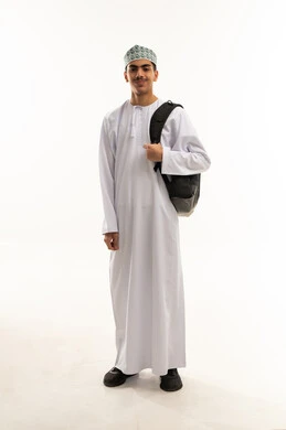Academic education in educational institutions in the Sultanate of Oman, back-to-school season, a portrait of an Arab Gulf Omani student wearing a dishdasha and kumma, carrying a backpack, looking at the camera with gestures of happiness and joy, full-body, white background. Academic education in educational institutions in the Sultanate of Oman, back-to-school season, a portrait of an Arab Gulf Omani student wearing a dishdasha and kumma, carrying a backpack, looking at the camera with gestures of happiness and joy, full-body, white background.
