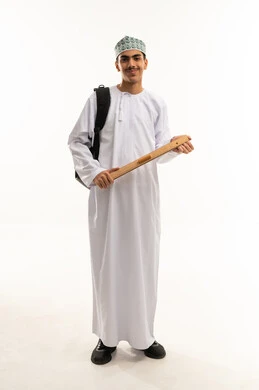 The importance of education in building a bright future for Omani society, measuring distances and drawing straight lines with a wooden ruler, a portrait of a Gulf Arab high school student from Saudi Arabia and Oman wearing a dishdasha and kumma, with a backpack looking at the camera with gestures of habit and joy, full-body image, white background.