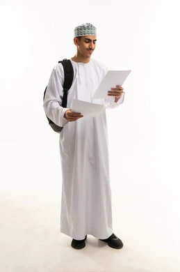 Higher education in the Sultanate of Oman, preparation for the new academic year, a portrait of an Arab Gulf Omani high school student wearing a dishdasha and kumma, carrying a bag on his back and holding study papers in his hands, full-body, white background.