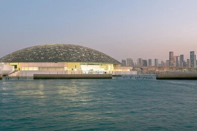 Famous tourist places and landmarks in the United Arab Emirates, distinctive designs and decorations, the architectural art of towers and skyscrapers in the modern style, an Emirati vision of the future, the Louvre Museum overlooking the Arabian Gulf coast during the day in the Emirate of Dubai