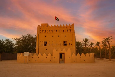 Ancient mud buildings, architectural designs of ancient forts and castles, the ancient Al Anka Fort in Abu Dhabi at sunset, famous landmarks and tourist attractions in the United Arab Emirates
