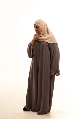 Feeling unwell and coughing, a portrait of an elderly Arab Saudi Gulf woman wearing a hijab and an abaya, suffering from cough, influenza, and pneumonia, infected with the coronavirus COVID-19, full-body, white background. Feeling unwell and coughing, a portrait of an elderly Arab Saudi Gulf woman wearing a hijab and an abaya, suffering from cough, influenza, and pneumonia, infected with the coronavirus COVID-19, full-body, white background.