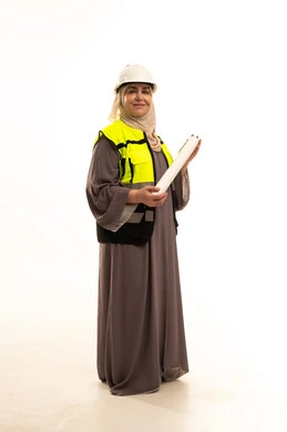 Engineering project management, working in the engineering sector, architectural designs and plan auditing, a portrait of an elderly Saudi Gulf Arab female engineer wearing a hijab, safety vest, and helmet, holding a construction plan and looking with gestures of happiness and joy, women's professions and jobs, white background.