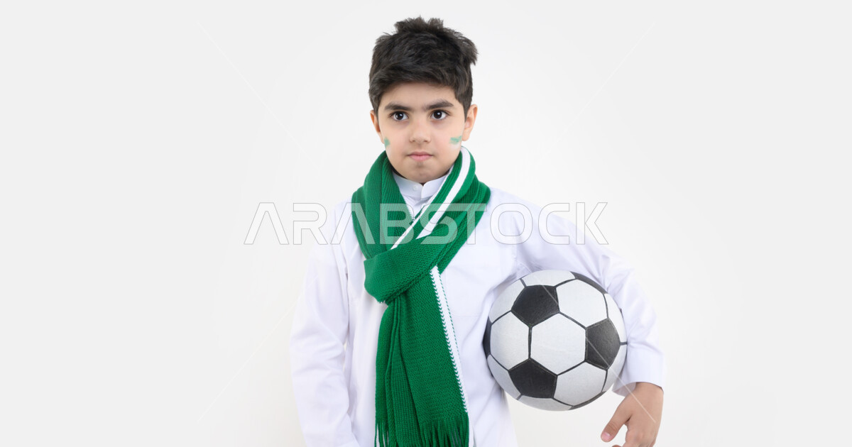 Portrait of a Saudi Arabian Gulf Arab boy holding a soccer ball ...