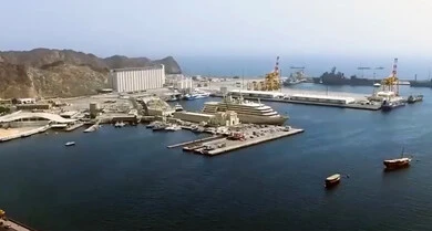 Resorts and chalets by the sea, the natural marine and mountainous formations on the coast of the Sultanate of Oman, coastal recreational trips, the port of ships and yachts in broad daylight, and famous natural tourist sites and landmarks.