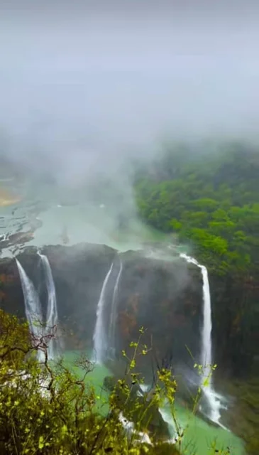 Wadi Darbat in the Wilayat of Taqah in the Dhofar Governorate, natural waterfalls and foggy atmosphere on the mountain slopes and foothills, Salalah waterfalls in the Sultanate of Oman, tourist places for hiking and spending a pleasant time, enjoying the natural scenery among the trees and dense green plants on the mountains