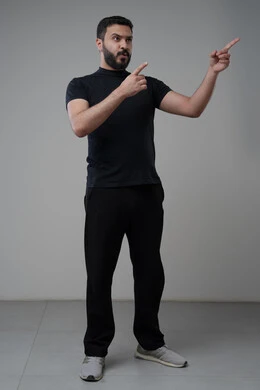 Using modern advanced technology in practical life, working remotely via mobile, gestures of integration and concentration, portrait of a young Saudi Arabian Gulf man wearing casual clothes sitting on a chair working on a mobile phone, gray background