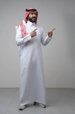 Looking up with an expression of concentration, portrait of a Saudi Arabian Gulf man wearing a traditional shemagh and thobe pointing at something, indicating a specific place, full body image, gray background