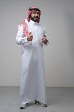 Using modern technology and techniques, browsing social media. Close-up portrait of a Saudi Arabian Gulf man wearing a traditional thobe and keffiyeh working on a tablet. Chatting with family and friends on the tablet with an expression of engagement. Gray background.  Thumbs up, looking at the camera with expressions of admiration and satisfaction. Portrait of a Saudi Arabian Gulf man wearing a keffiyeh and traditional thobe looking at the camera with gestures of acceptance and approval. Full-l