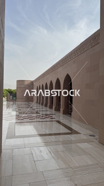 Performing religious duties, modern Islamic architecture, famous Islamic religious sites and landmarks in the Sultanate of Oman, Sultan Qaboos Grand Mosque in Muscat Governorate in the Sultanate of Oman, arches in the corridor of the Sultan's Mosque, worship and drawing closer to God
