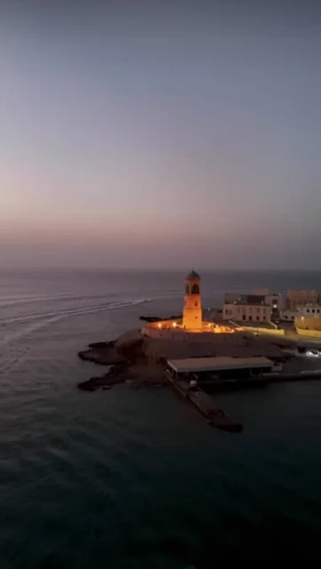 Ras Al Mail Tower in the Sultanate of Oman, Al Aija Lighthouse illuminated at night in the Wilayat of Sur, the oldest lighthouse in Oman, a historical tourist attraction, the architectural art of maritime heritage