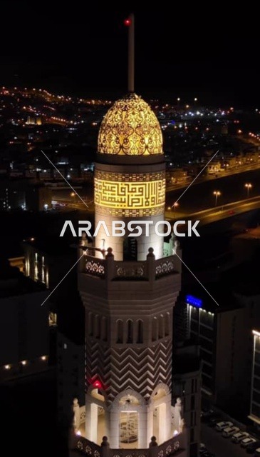 Worship and closeness to God, performing religious duties, modern Islamic architectural art of the mosques of Muscat Governorate, famous sacred Islamic religious places and landmarks in the Sultanate of Oman, the illuminated domes and minarets of the Mohammed Al-Amin Mosque at night in the Wilayat of Bausher