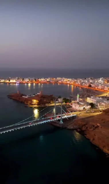 Khor Al Batha Suspension Bridge in the Wilayat of Sur in the Sultanate of Oman, the bridge linking the center of the Wilayat of Sur and the Al Aija area at night, the most important architectural and cultural achievements and landmarks in the region
