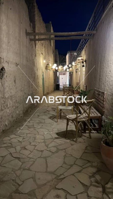 A narrow stone alley in Wadi Al Hawqayn, traditional mud houses in the Wilayat of Rustaq in the South Al Batinah Governorate, tourist places for walking and spending a pleasant time in the Sultanate of Oman, enjoying natural areas, a quiet session in one of the old neighborhoods