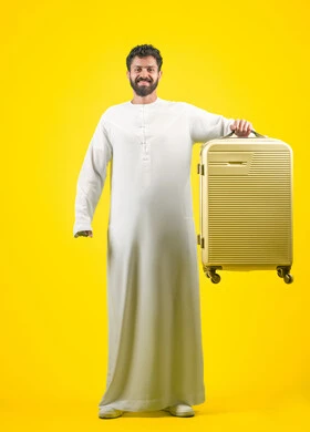 Looking at the camera with gestures of happiness and joy, taking recreational trips during the summer vacation, portrait of a young Arab Emirati man wearing a kandura carrying a suitcase, the concept of tourism and travel, preparing for a pleasant summer trip, full-length body image, yellow background