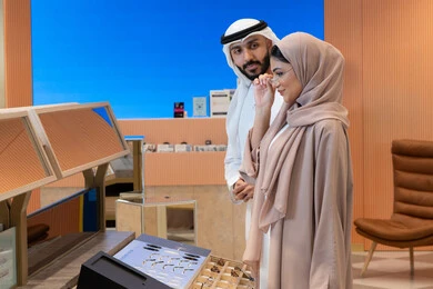Elegance and interest in outward appearance, purchasing accessories from malls, keeping up with the latest fashion and beauty trends, international types and brands, an Arab Gulf Emirati couple choosing eyeglasses that suit their facial features, enjoying shopping in the malls of the Emirates, the concept of weak eyesight