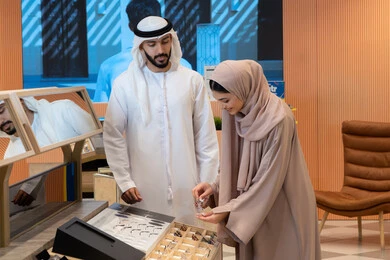 International brands and types, an Arab Gulf Emirati couple choosing eyeglasses that suit their facial features, the pleasure of shopping in the UAE malls, the concept of weak eyesight, elegance and interest in one's appearance, keeping up with the latest fashion and beauty trends, and purchasing accessories from malls.