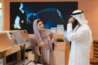 Enjoy shopping in the Emirates malls, keep up with the latest fashion and beauty trends, elegance and attention to one's appearance, an Arab Gulf Emirati couple choosing sunglasses that suit their facial features, protecting their eyes from the sun's rays